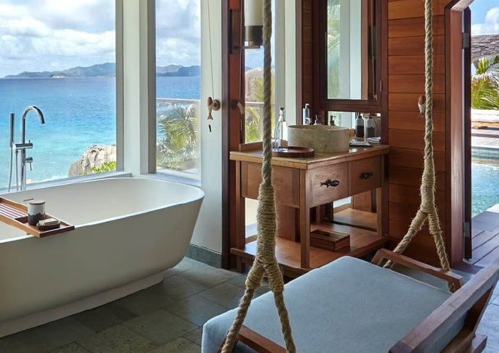 Bathroom with an ocean view and a swing seat in the Seychelles